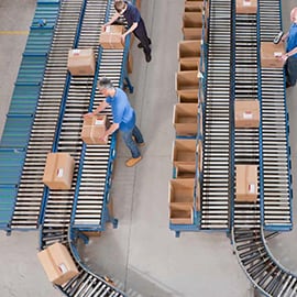 Overhead shot of workers handling packages in conveyor belts